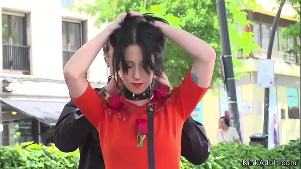 Marionette in crimson sundress abjected in public